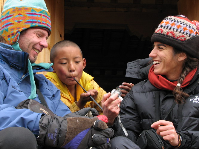 Kerri and Ray talking with a small monk at Drirapuk Monastery. Mt. Kailash, Tibet.